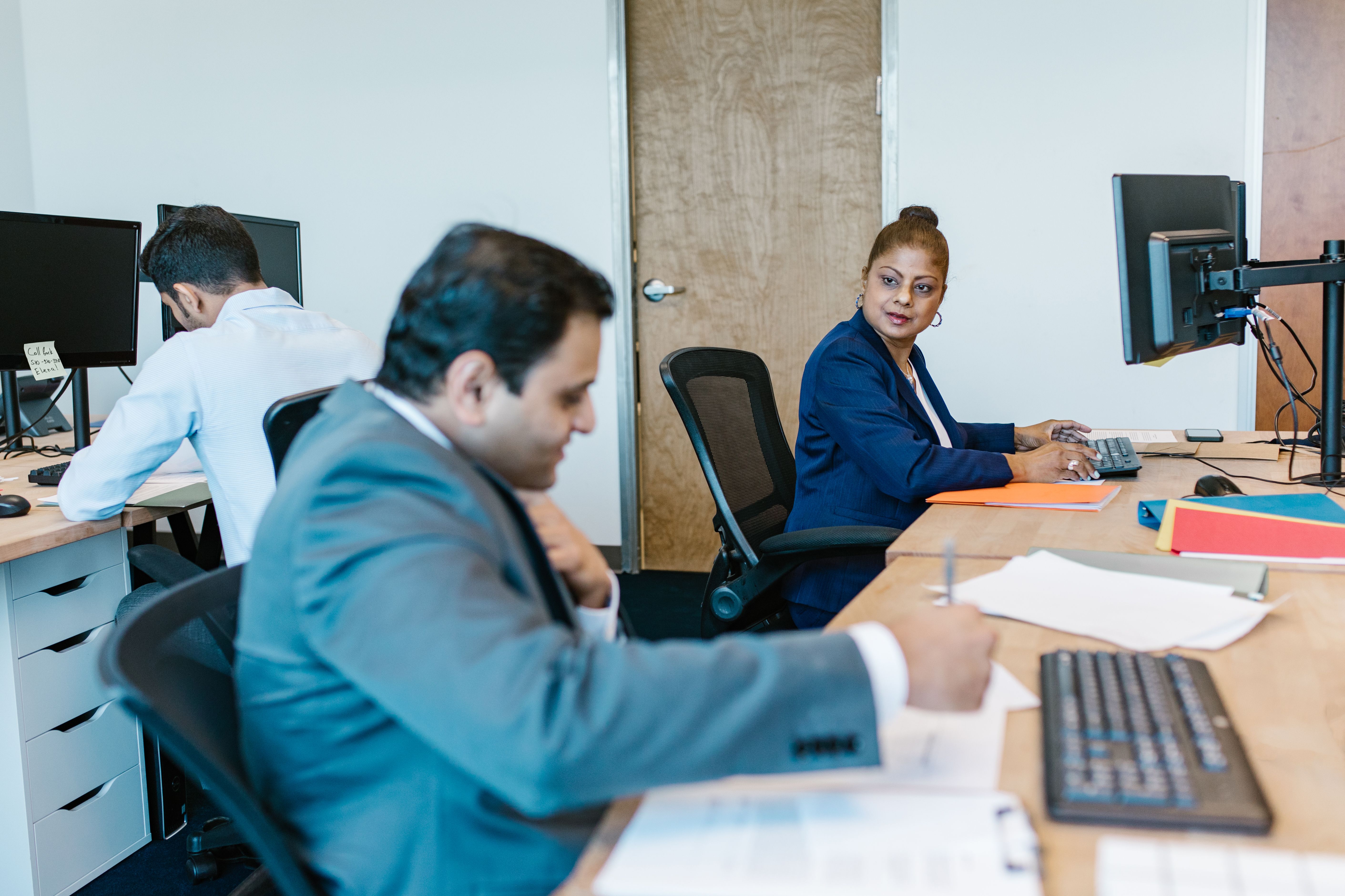 The YourFinanceFeed advisory team reviewing client portfolios in their London office